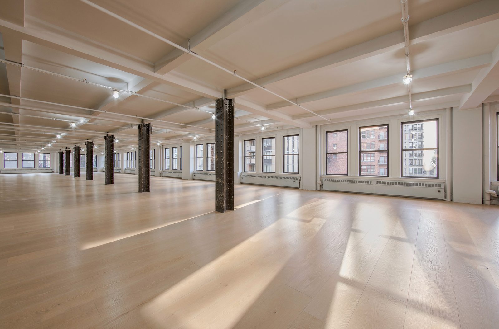 Raw office space with exposed ceiling and windows
